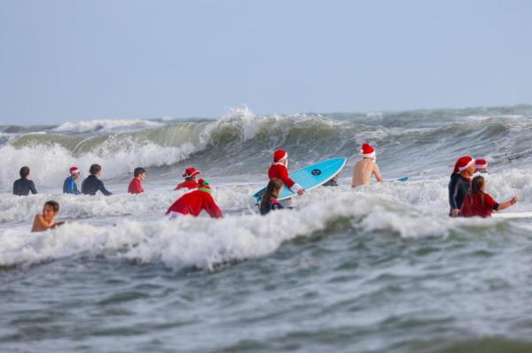 Surfing Santas ride waves, raise funds in Florida