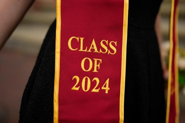 A recent graduate wears a garment with their graduation year on the University of Southern California campus Thursday, April 25, 2024
